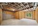 Unfinished basement with exposed framing and a window, offering potential for customization at 220 Autumn Brook Dr, Canton, GA 30115