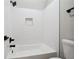 Bathroom featuring white subway tile in shower, white tub, black shower head and fixtures and gray walls at 220 Autumn Brook Dr, Canton, GA 30115