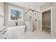 Bright bathroom featuring a soaking tub, glass shower, and granite counters at 220 Autumn Brook Dr, Canton, GA 30115