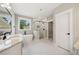 Bright bathroom featuring a soaking tub, glass shower, and granite counters at 220 Autumn Brook Dr, Canton, GA 30115