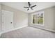 Bright bedroom featuring a large window and carpet flooring at 220 Autumn Brook Dr, Canton, GA 30115