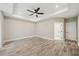 Bright bedroom featuring a tray ceiling, ceiling fan, and wood-look flooring at 220 Autumn Brook Dr, Canton, GA 30115