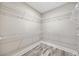 Spacious walk-in closet featuring wire shelving and wood-look flooring at 220 Autumn Brook Dr, Canton, GA 30115