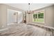 Dining area showcases wood floors, a stylish light fixture, and natural light from large windows at 220 Autumn Brook Dr, Canton, GA 30115