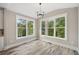 Dining room with a view, featuring hardwood floors, crown molding, and bright, natural lighting at 220 Autumn Brook Dr, Canton, GA 30115