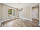 Bright dining room features hardwood floors, a modern chandelier, and a large window at 220 Autumn Brook Dr, Canton, GA 30115