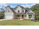 Charming two-story home with gray siding, a covered front porch, an attached two-car garage, and mature landscaping at 220 Autumn Brook Dr, Canton, GA 30115