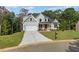 Beautiful new construction home with a gray facade, well-manicured lawn, and attached garage at 220 Autumn Brook Dr, Canton, GA 30115