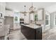 Bright kitchen with granite counters, center island with cooktop, and stainless steel appliances at 220 Autumn Brook Dr, Canton, GA 30115