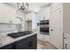 Elegant kitchen features granite counters, stainless steel appliances, and white cabinetry at 220 Autumn Brook Dr, Canton, GA 30115