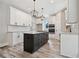 Kitchen features a dark island, stainless appliances, white cabinetry, and granite countertops at 220 Autumn Brook Dr, Canton, GA 30115