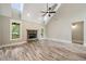 Spacious living room with stone fireplace, large windows, and views of the outdoor deck at 220 Autumn Brook Dr, Canton, GA 30115