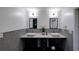 Contemporary bathroom with double vanity and penny tile at 1043 Smith Sw St, Atlanta, GA 30310