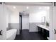 Modern bathroom with double vanity, soaking tub, and hexagon tile floors at 1043 Smith Sw St, Atlanta, GA 30310
