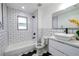 Clean bathroom with subway tile and black hexagon floor at 1043 Smith Sw St, Atlanta, GA 30310