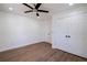 Bedroom with wood floors, ceiling fan, and double doors at 1043 Smith Sw St, Atlanta, GA 30310
