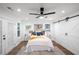 Bright bedroom with wood floors, ceiling fan, and barn doors at 1043 Smith Sw St, Atlanta, GA 30310