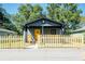Charming gray house with yellow door, wood fence, and covered porch at 1043 Smith Sw St, Atlanta, GA 30310