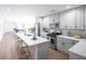 Modern kitchen with white cabinets, quartz countertops, and island at 1043 Smith Sw St, Atlanta, GA 30310