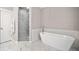 Elegant bathroom featuring a freestanding tub and marble tile at 228 Dawson Dr, Woodstock, GA 30188