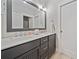 Double vanity bathroom with gray cabinets and large mirror at 228 Dawson Dr, Woodstock, GA 30188