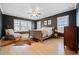 Spacious main bedroom with hardwood floors and ceiling fan at 228 Dawson Dr, Woodstock, GA 30188