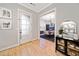 Bright and airy entryway with hardwood floors and view into dining area at 228 Dawson Dr, Woodstock, GA 30188