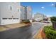 Rear view of townhouses showing garages and a quiet street at 228 Dawson Dr, Woodstock, GA 30188