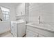Bright laundry room with washer, dryer, and utility sink at 228 Dawson Dr, Woodstock, GA 30188