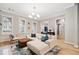 Spacious living room with light colored sectional sofa and hardwood floors at 228 Dawson Dr, Woodstock, GA 30188
