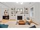 Living area with a cozy fireplace, built-in shelving and hardwood floors at 228 Dawson Dr, Woodstock, GA 30188