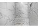 Clean and modern shower with marble tile and bench at 228 Dawson Dr, Woodstock, GA 30188