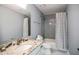 Updated bathroom with granite countertop and gray tile shower at 3581 Baywater Trl, Snellville, GA 30039