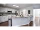 Modern kitchen with white cabinets, granite countertops, and a large island at 3581 Baywater Trl, Snellville, GA 30039