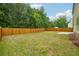 Private backyard with a wooden fence and grassy lawn at 150 Shaker Hollow Dr, Mcdonough, GA 30253