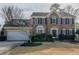 Two-story brick home with a large front yard and attached garage at 4975 Cinnabar Dr, Alpharetta, GA 30022