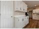 White kitchen cabinets and quartz countertops with added storage at 4975 Cinnabar Dr, Alpharetta, GA 30022