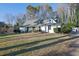 White ranch style home with green roof and well-manicured lawn at 257 Regal Nw Dr, Lawrenceville, GA 30046