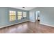 Light blue bedroom with wood-look floors and en-suite bathroom at 293 Quail Run, Roswell, GA 30076