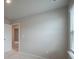 Simple bedroom with neutral walls and window blinds at 337 Amsterdam Way, Hampton, GA 30228