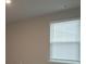 Simple bedroom with neutral walls and window blinds at 337 Amsterdam Way, Hampton, GA 30228