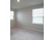 Simple bedroom with neutral walls and carpet at 337 Amsterdam Way, Hampton, GA 30228