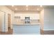 Kitchen with island and stainless steel appliances at 337 Amsterdam Way, Hampton, GA 30228