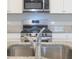 Modern kitchen with stainless steel appliances and granite countertops at 337 Amsterdam Way, Hampton, GA 30228
