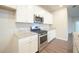 Modern kitchen with stainless steel appliances and granite countertops at 337 Amsterdam Way, Hampton, GA 30228