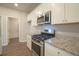 Modern kitchen with stainless steel appliances and granite countertops at 337 Amsterdam Way, Hampton, GA 30228