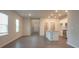 Open concept living room and kitchen with hardwood floors at 337 Amsterdam Way, Hampton, GA 30228