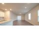 Open living room with hardwood floors and access to patio at 337 Amsterdam Way, Hampton, GA 30228