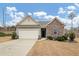 Brick and gray siding ranch home with attached garage and landscaping at 7250 Lacey Dr, Douglasville, GA 30134