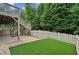 Artificial turf backyard with a wooden fence and deck at 2725 Castel Ln, Cumming, GA 30040